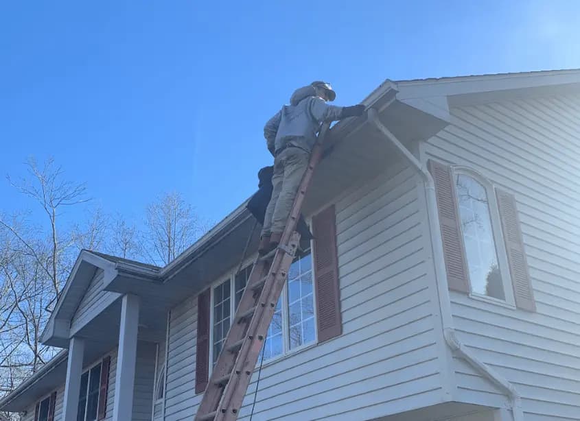 Gutter cleaning and maintenance being performed by Streetsboro Power Washing in Streetsboro